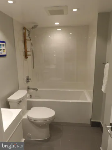 a bathroom with a sink mirror vanity and toilet