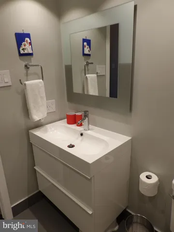a bathroom with a sink mirror and shower