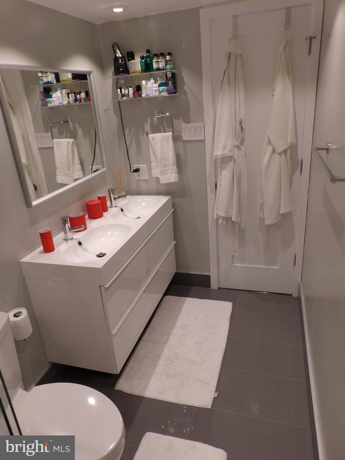 1800 Old Meadow Road, Unit 902 McLean, VA 22102 - Photo 43 of 67 a bathroom with a sink mirror vanity and toilet