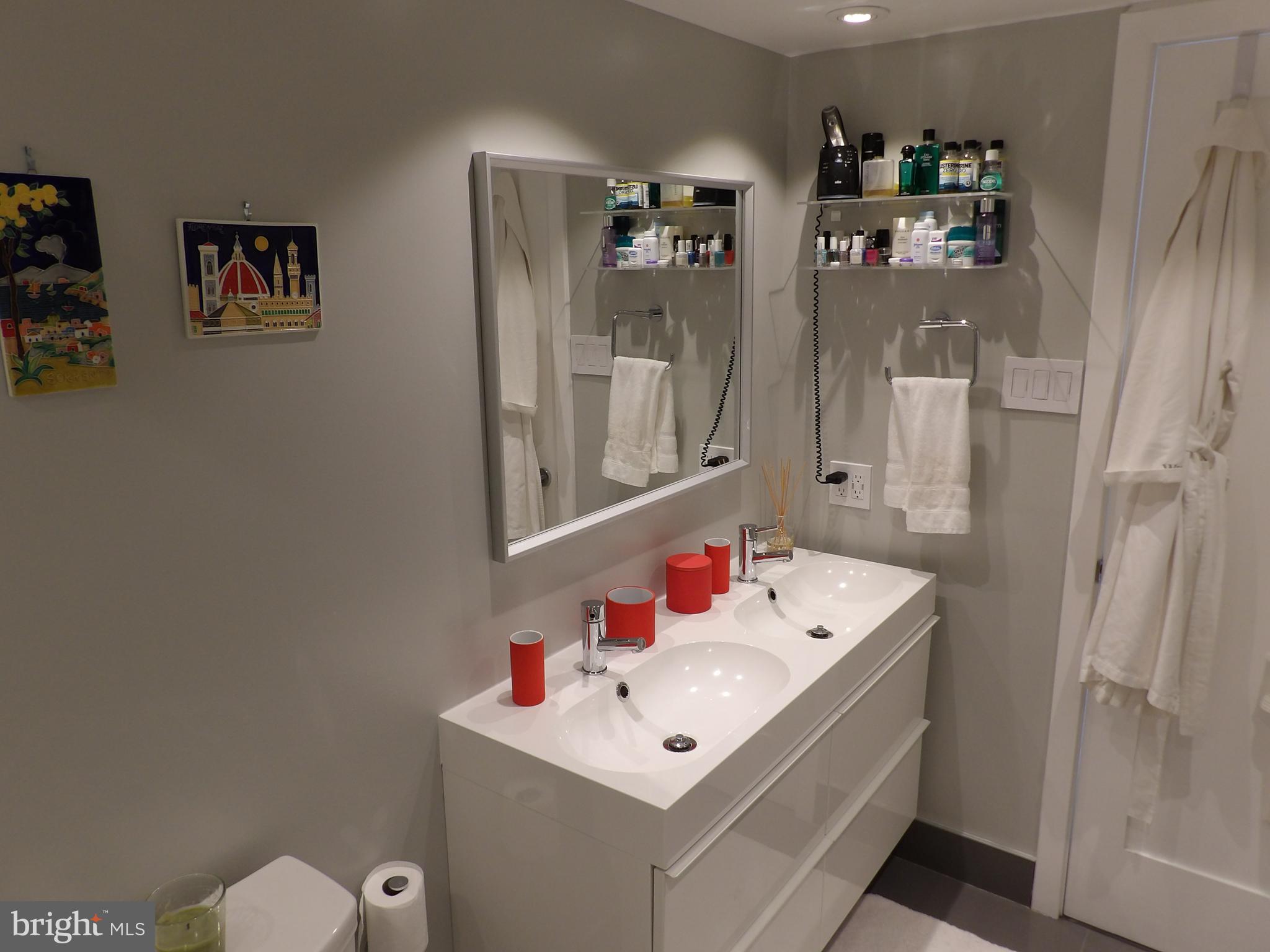 1800 Old Meadow Road, Unit 902 McLean, VA 22102 - Photo 44 of 67 a bathroom with a sink mirror and shower