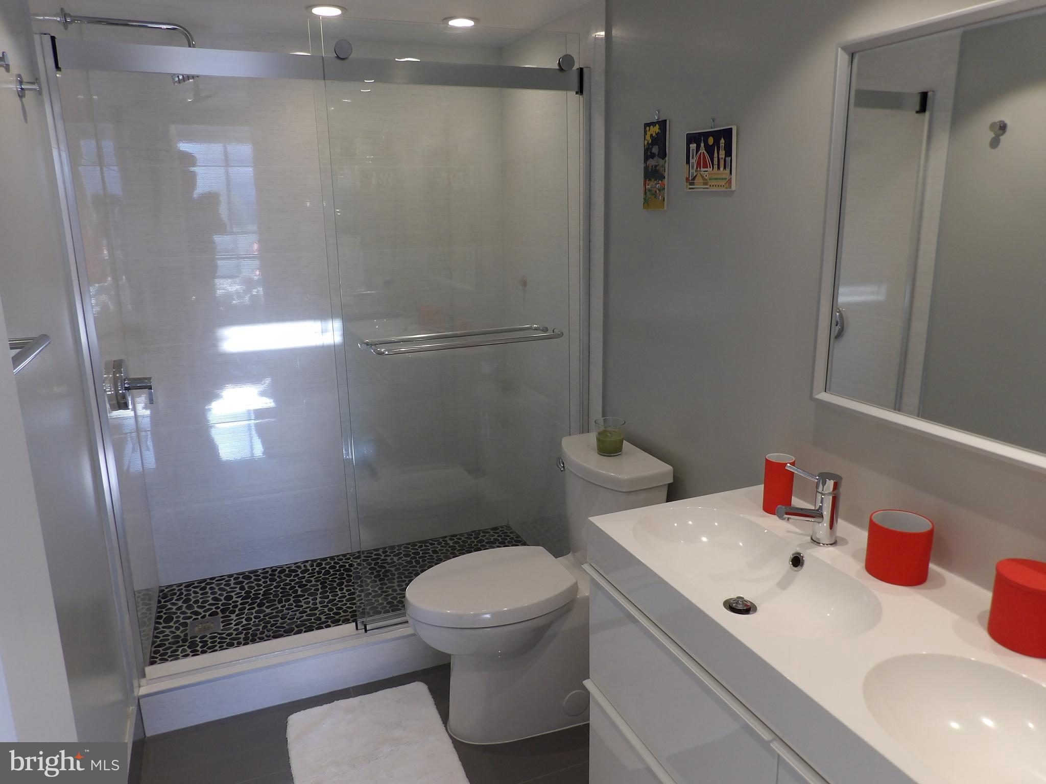 1800 Old Meadow Road, Unit 902 McLean, VA 22102 - Photo 45 of 67 a bathroom with a sink toilet and shower