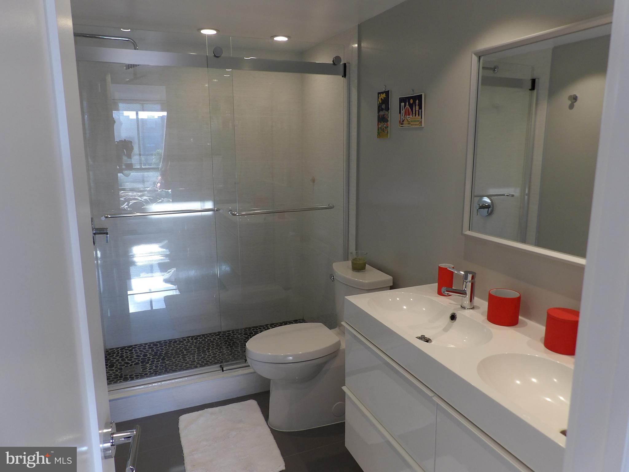 1800 Old Meadow Road, Unit 902 McLean, VA 22102 - Photo 46 of 67 a bathroom with a sink a toilet and shower