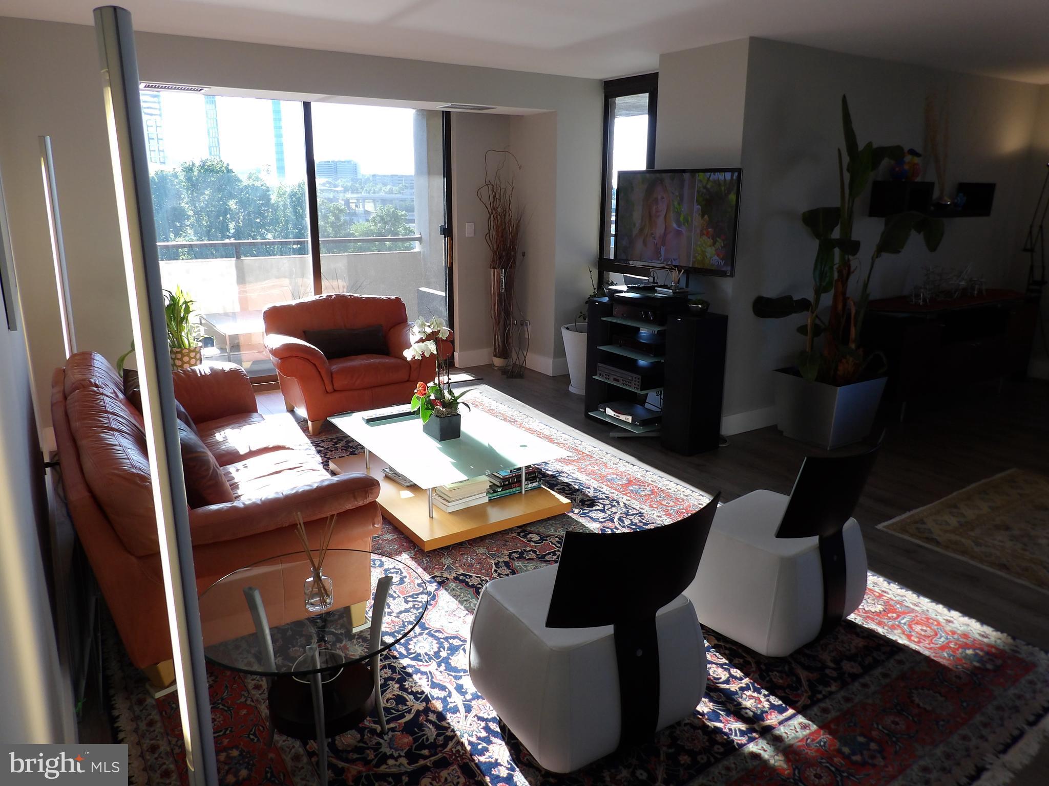 1800 Old Meadow Road, Unit 902 McLean, VA 22102 - Photo 50 of 67 a living room with furniture and a floor to ceiling window
