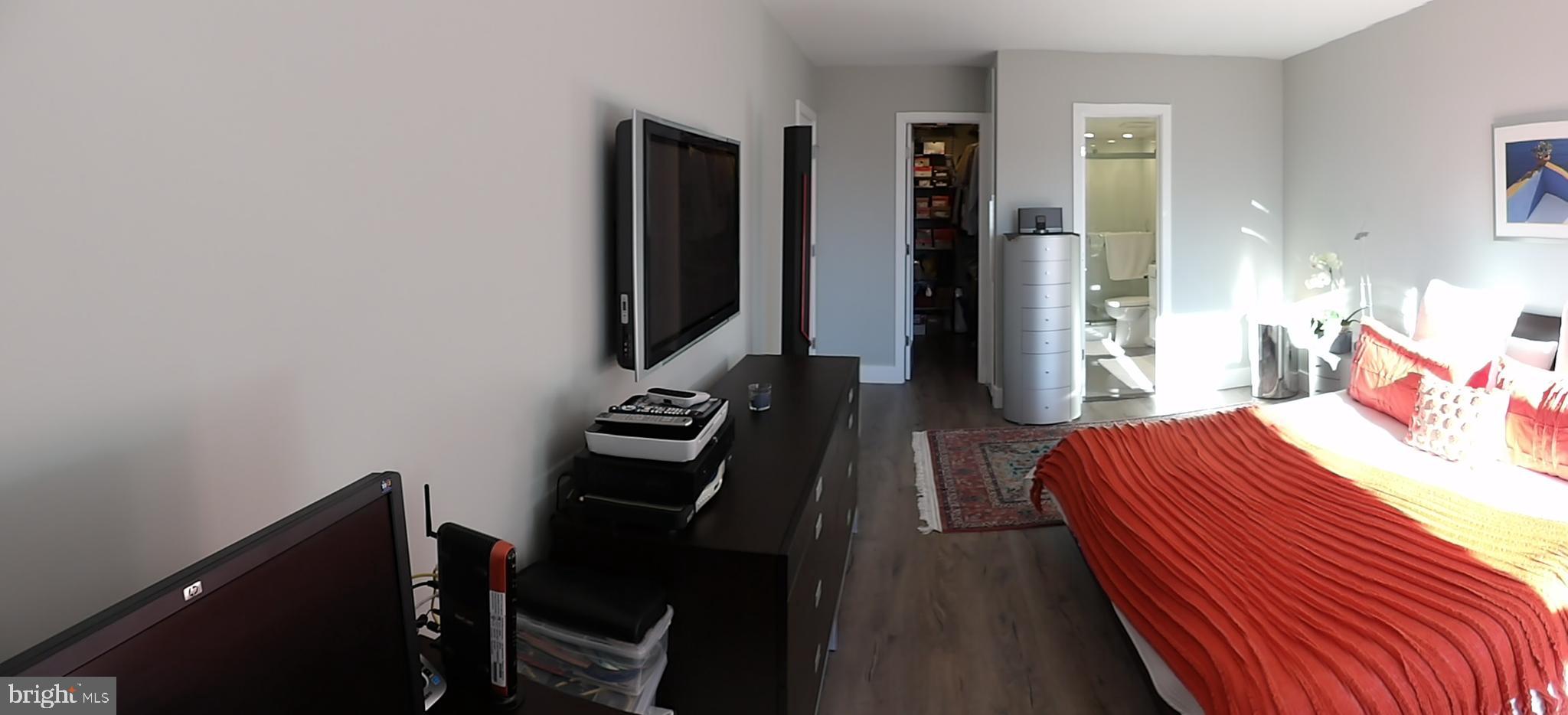 1800 Old Meadow Road, Unit 902 McLean, VA 22102 - Photo 57 of 67 a bedroom with a bed and a desk