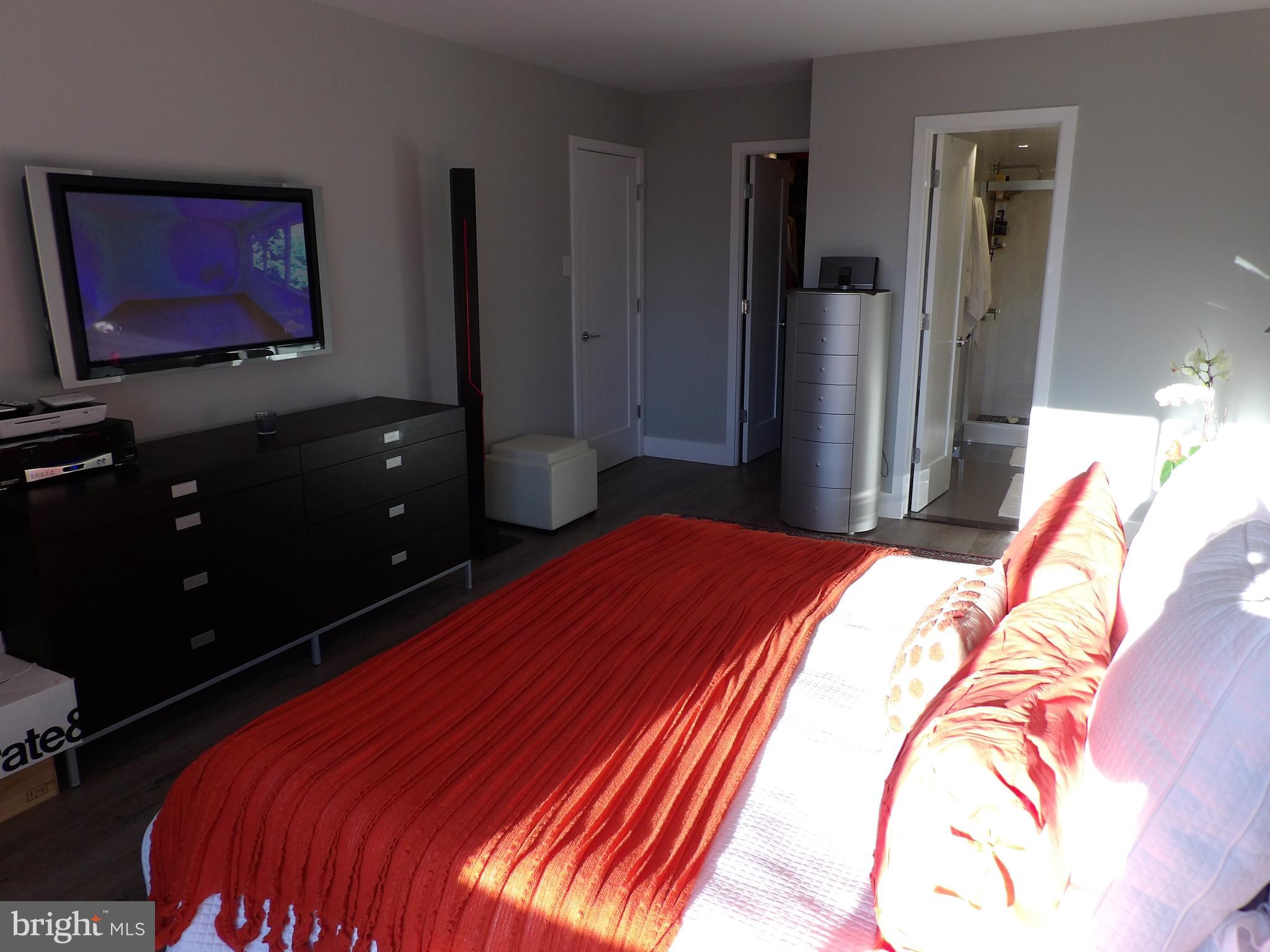 1800 Old Meadow Road, Unit 902 McLean, VA 22102 - Photo 58 of 67 a bedroom with a bed and a flat screen tv