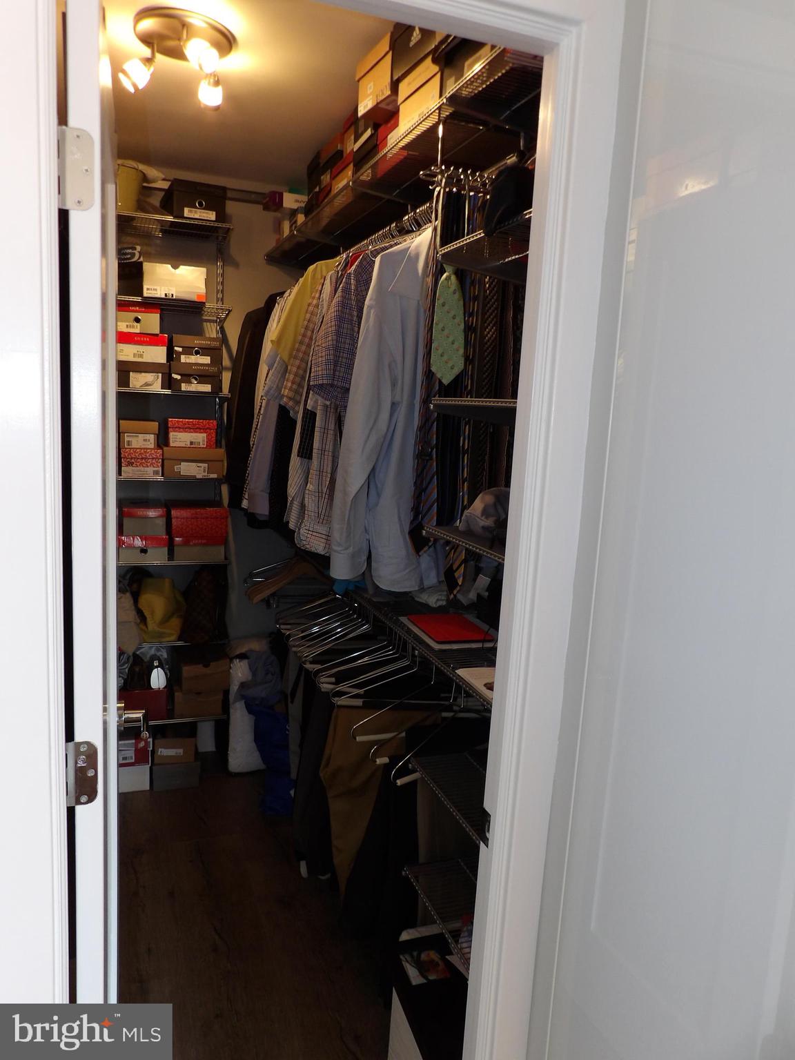1800 Old Meadow Road, Unit 902 McLean, VA 22102 - Photo 59 of 67 a view of walk in closet with clothes and shoes