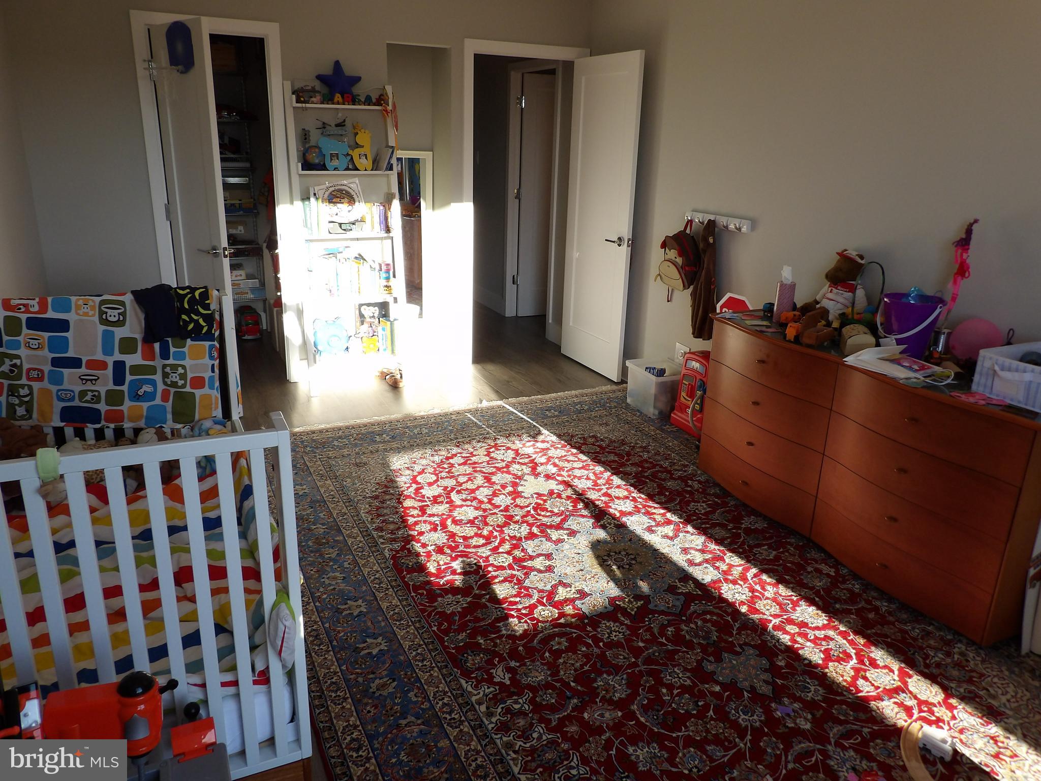 1800 Old Meadow Road, Unit 902 McLean, VA 22102 - Photo 61 of 67 a bedroom with bed and a book shelf