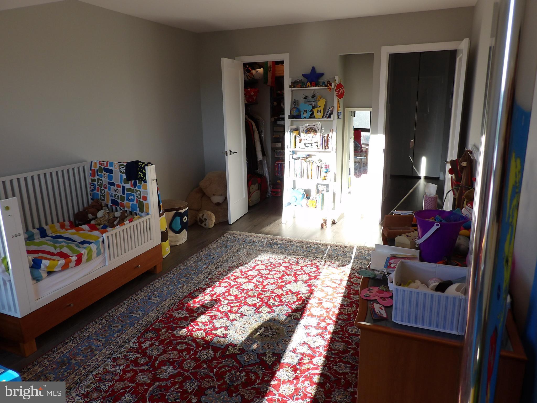 1800 Old Meadow Road, Unit 902 McLean, VA 22102 - Photo 62 of 67 a bedroom with bed and a rug