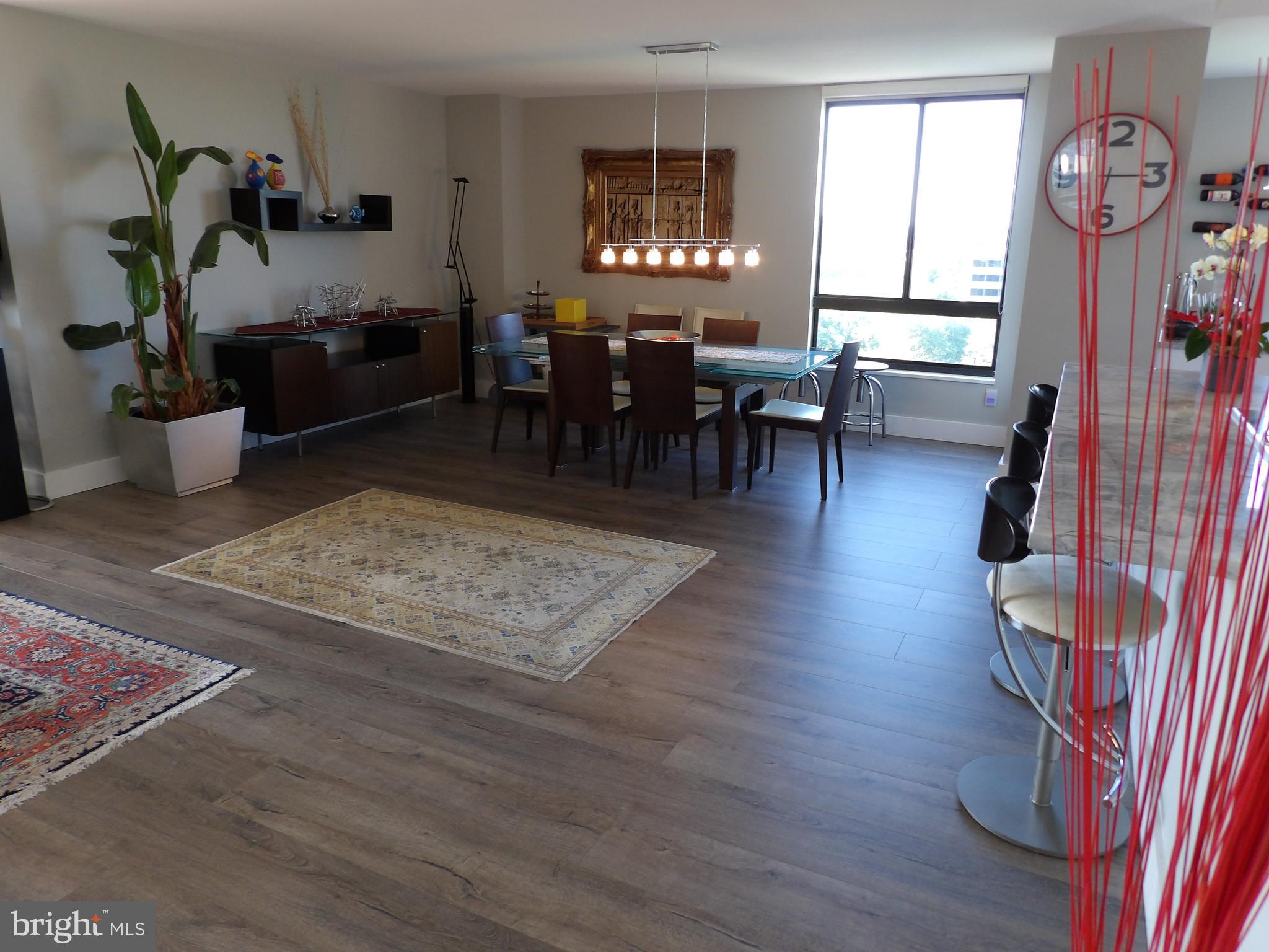 1800 Old Meadow Road, Unit 902 McLean, VA 22102 - Photo 7 of 67 a view of a dining room with furniture window and wooden floor
