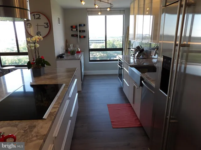 a kitchen with a sink a counter top space and appliances
