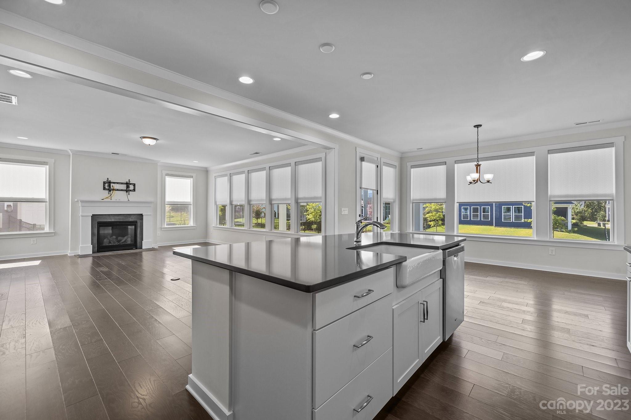 1256 Therns Ferry Drive Fort Mill, SC 29708 - Photo 11 of 47 a kitchen with kitchen island granite countertop a stove and wooden floor