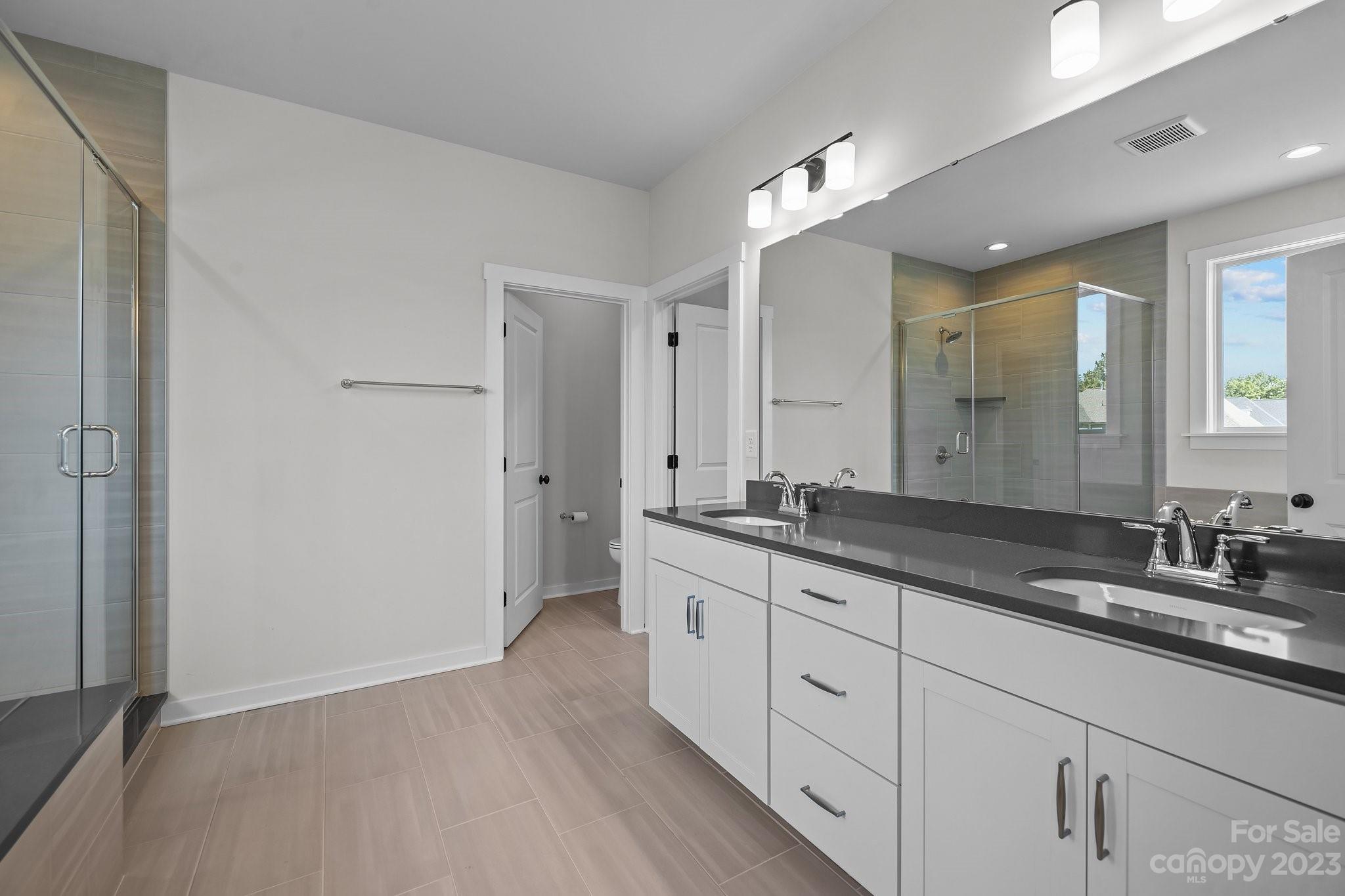 1256 Therns Ferry Drive Fort Mill, SC 29708 - Photo 21 of 47 a spacious bathroom with a granite countertop sink mirror and a