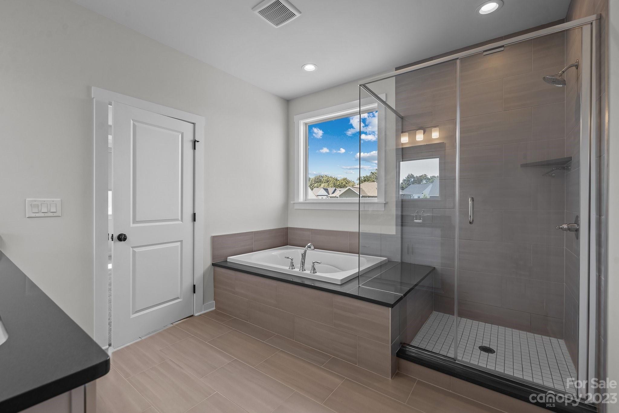 1256 Therns Ferry Drive Fort Mill, SC 29708 - Photo 22 of 47 a bathroom with a granite countertop sink a mirror and shower