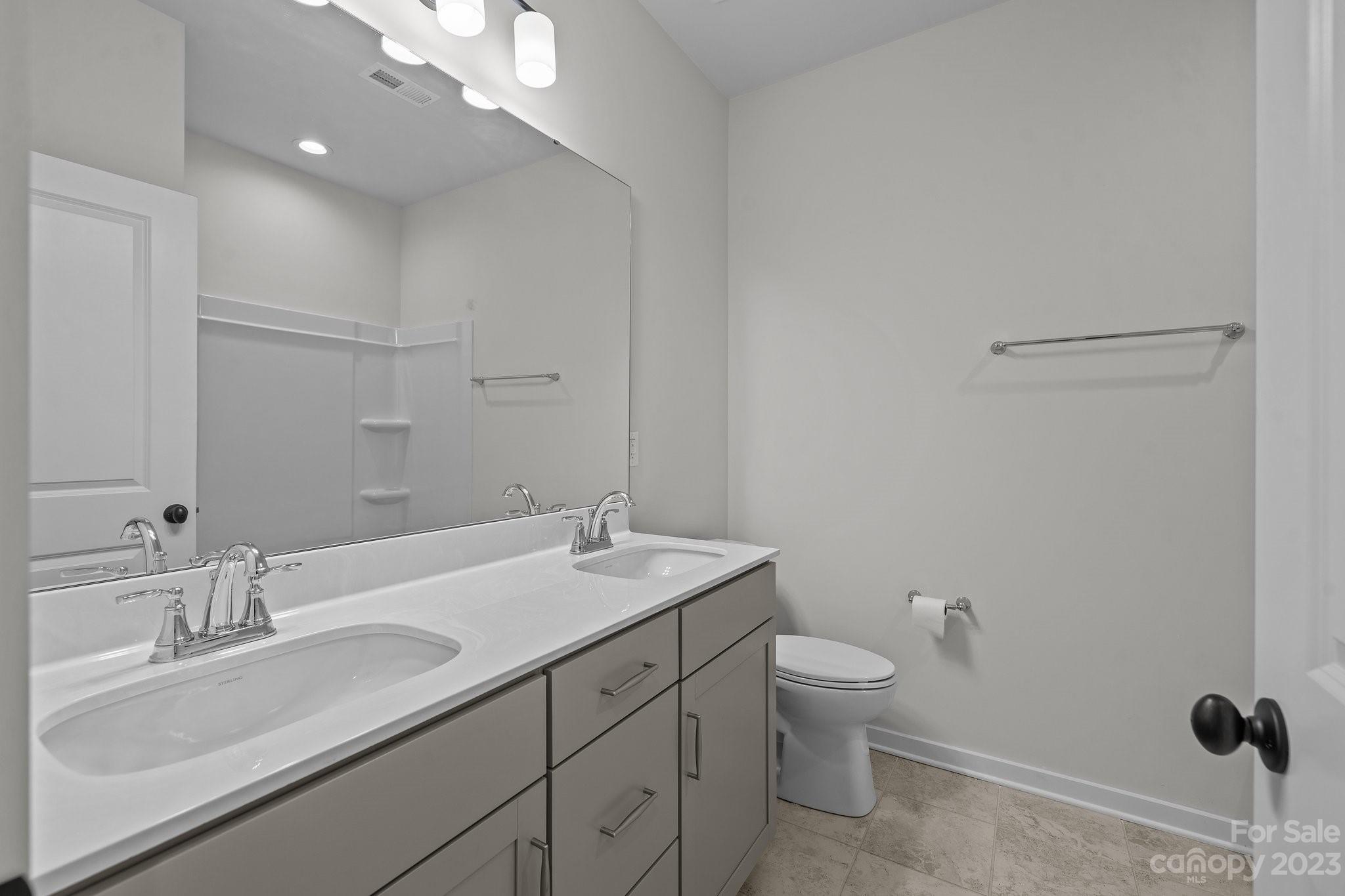 1256 Therns Ferry Drive Fort Mill, SC 29708 - Photo 30 of 47 a bathroom with a granite countertop sink a toilet and a mirror