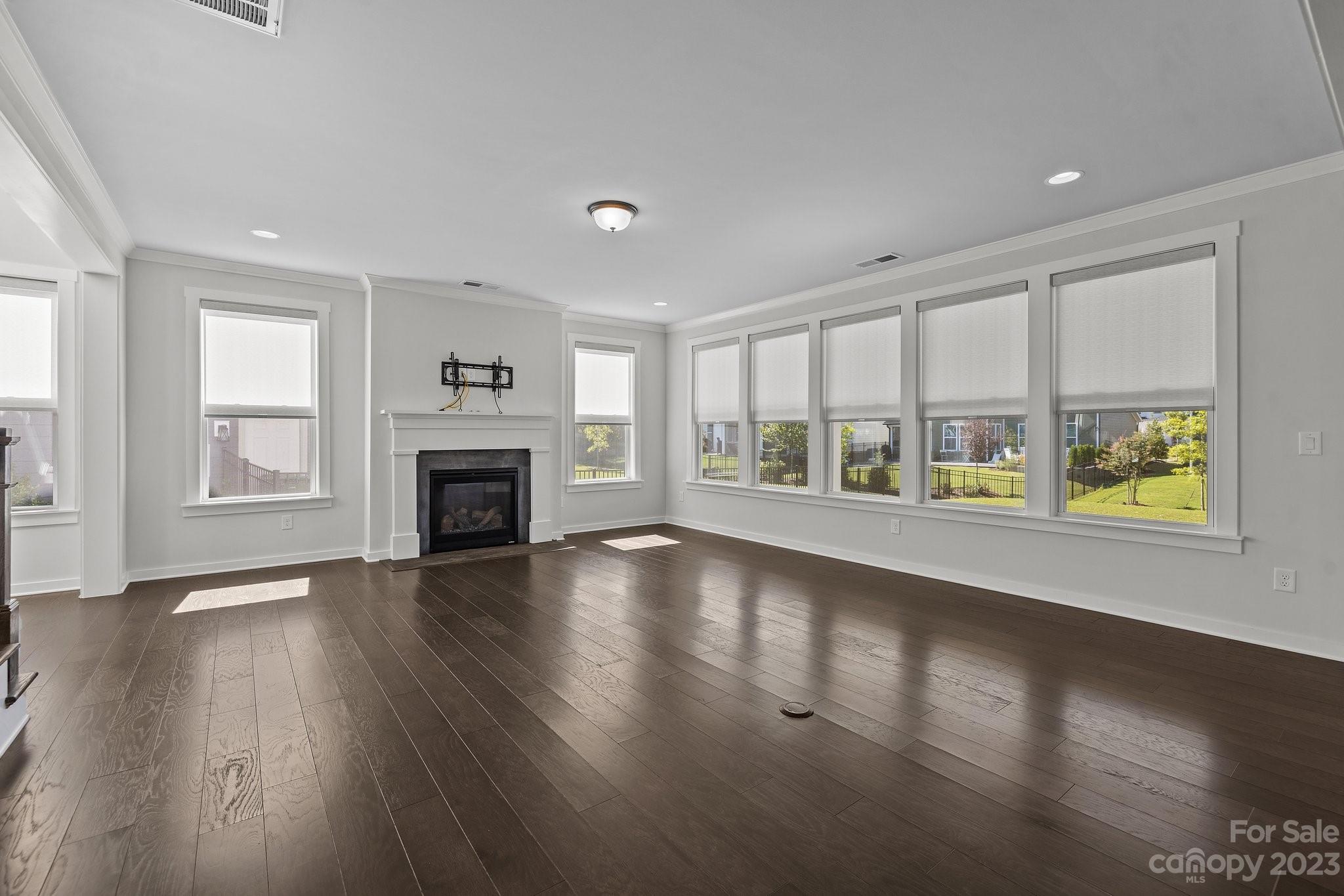 1256 Therns Ferry Drive Fort Mill, SC 29708 - Photo 7 of 47 an empty room with windows fireplace and windows