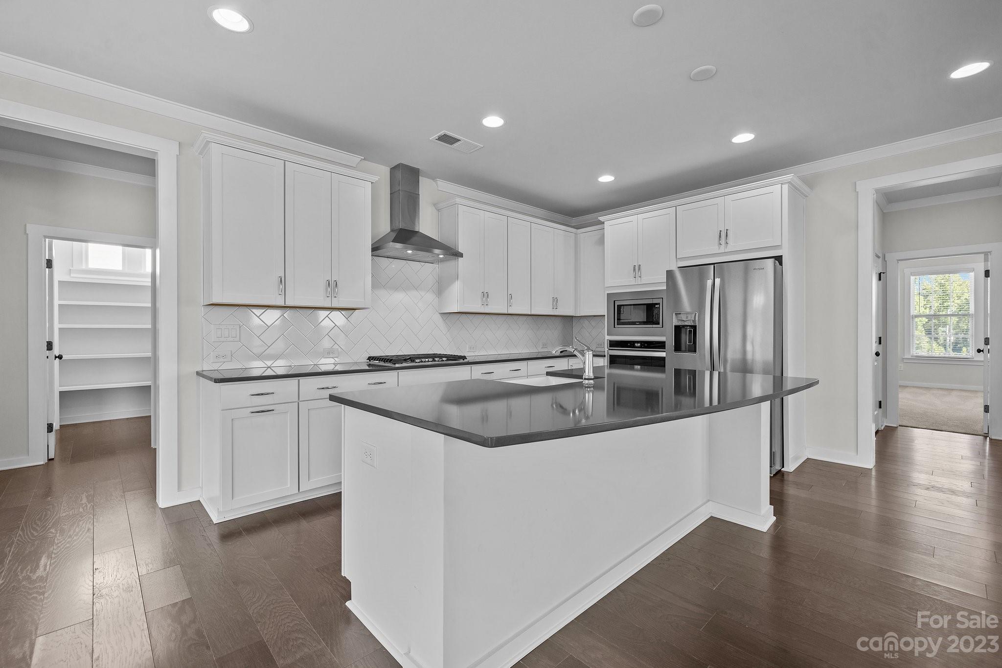 1256 Therns Ferry Drive Fort Mill, SC 29708 - Photo 9 of 47 a kitchen with granite countertop white cabinets and stainless steel appliances