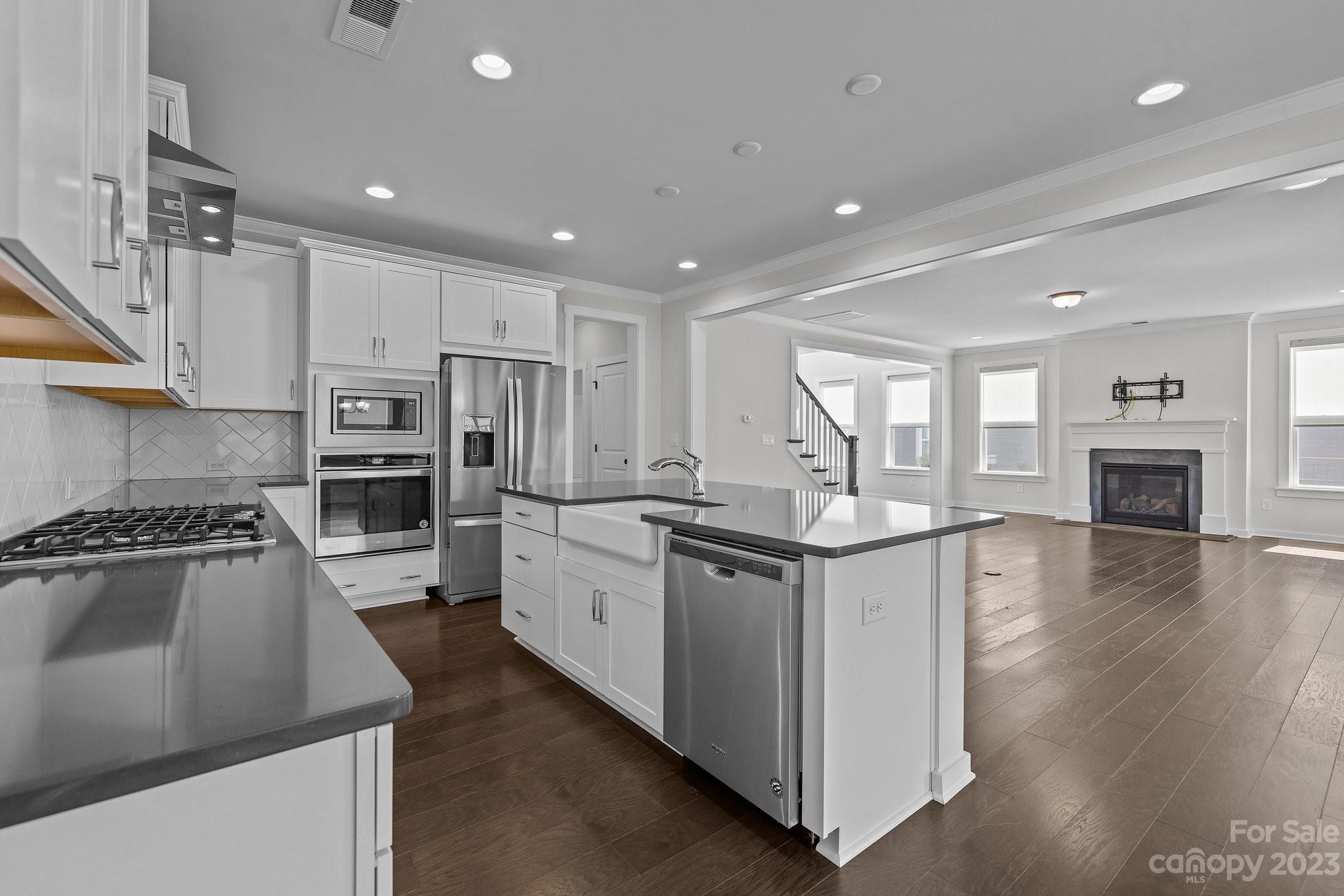 1256 Therns Ferry Drive Fort Mill, SC 29708 - Photo 10 of 47 a kitchen with stainless steel appliances granite countertop a sink stove and refrigerator