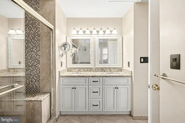 a bathroom with a double vanity sink mirror and