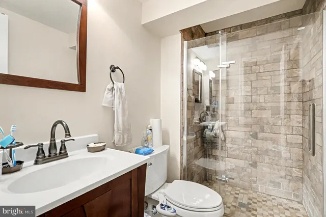 a bathroom with a sink toilet and shower