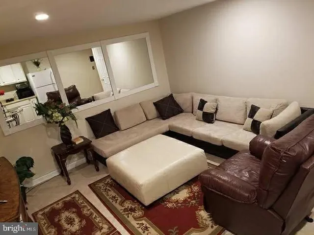 a living room with furniture and a rug