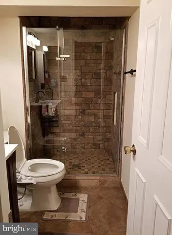 a bathroom with a toilet and a shower