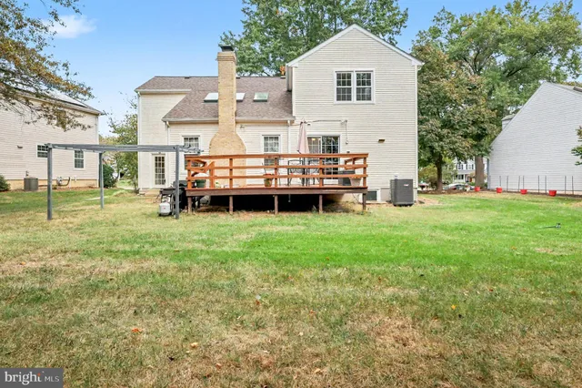a front view of a house with a garden and trees