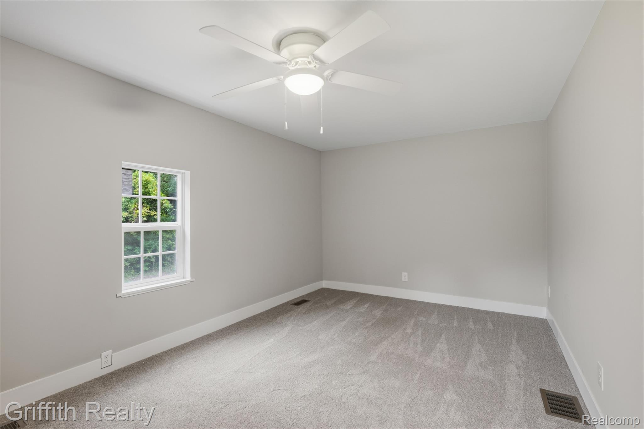 5820 Mack Road Howell, MI 48855 - Photo 21 of 60 Light gray carpeting, white trim, and a white ceiling fan with integrated lighting