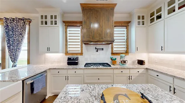 a kitchen with stainless steel appliances a sink stove and cabinets