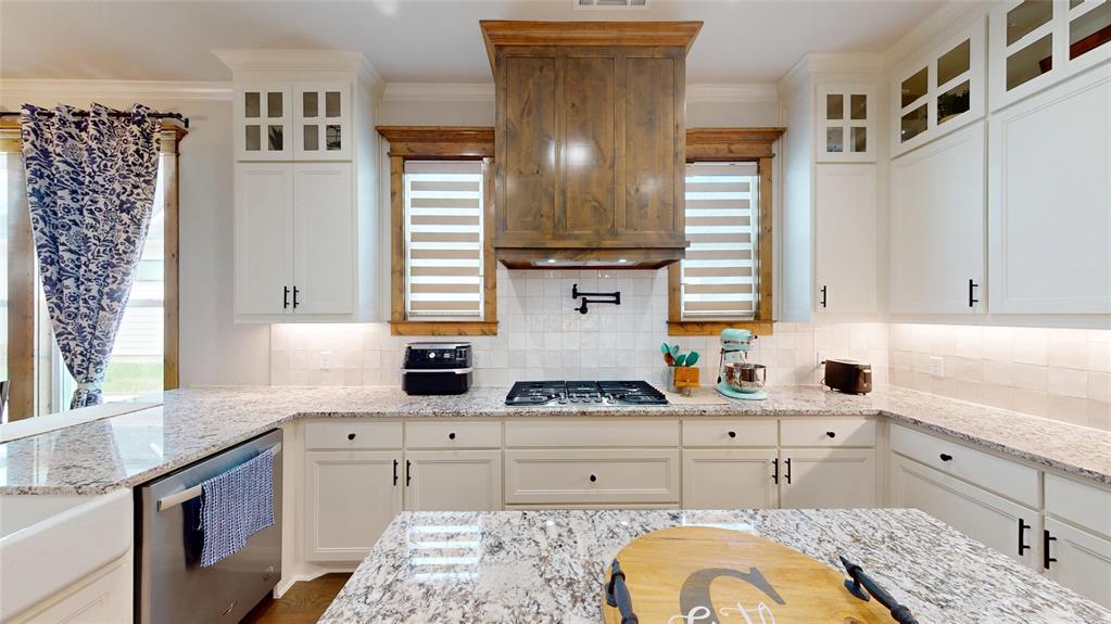 429 Skye Lane Midlothian, TX 76065 - Photo 11 of 29 a kitchen with stainless steel appliances a sink stove and cabinets