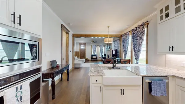a kitchen with sink stove and cabinets