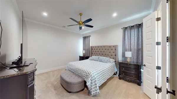 a bedroom with a bed and a chandelier