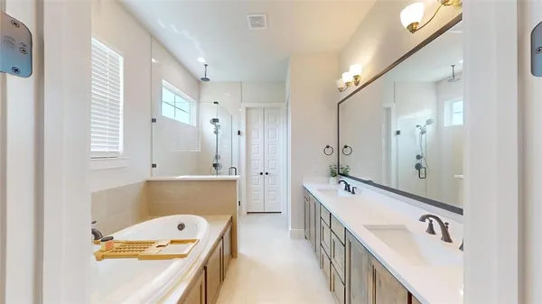 a bathroom with a tub sink and mirror