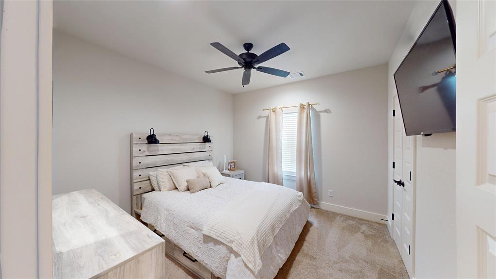 429 Skye Lane Midlothian, TX 76065 - Photo 20 of 29 a bedroom with a bed and a chandelier