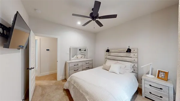 a bedroom with a bed and a flat tv screen