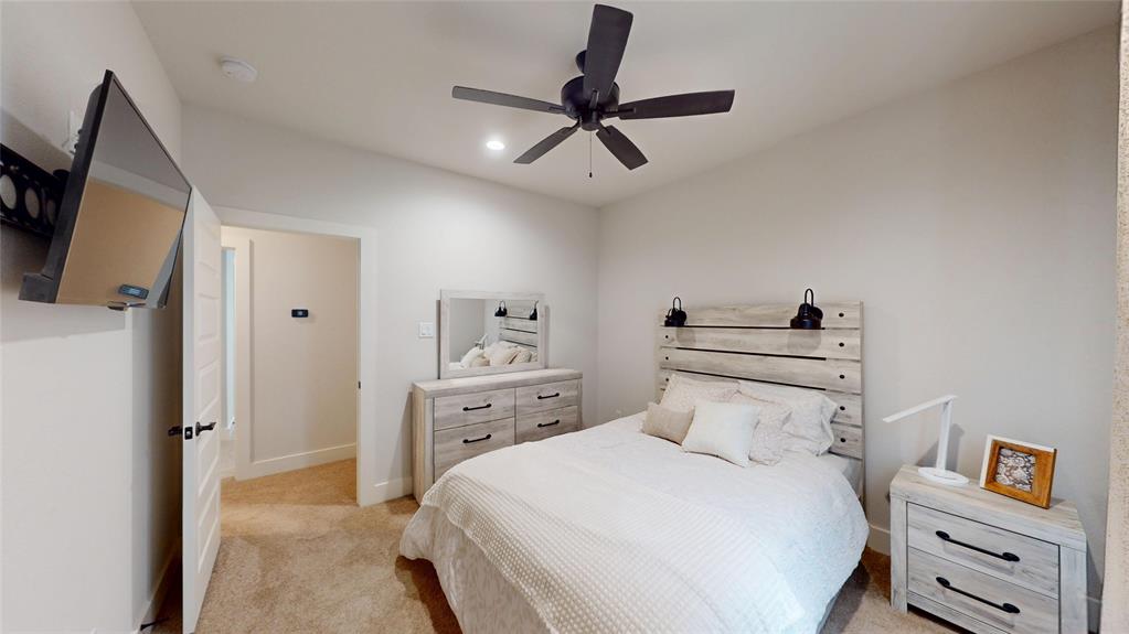 429 Skye Lane Midlothian, TX 76065 - Photo 21 of 29 a bedroom with a bed and a flat tv screen