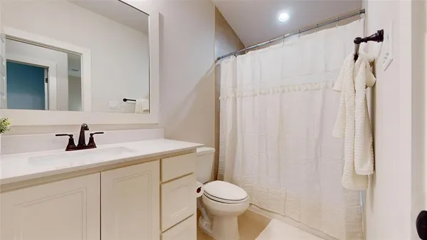 a bathroom with a sink vanity mirror and toilet