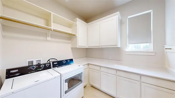 a view of a storage and utility room with washer and dryer