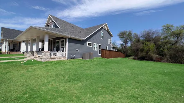 a front view of a house with a garden and yard