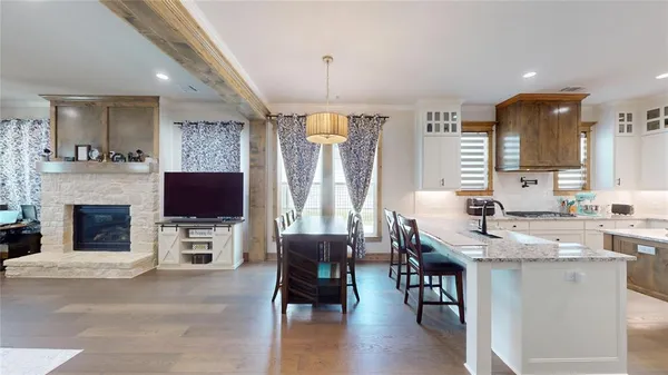 a view of kitchen with granite countertop microwave stove top oven and cabinets