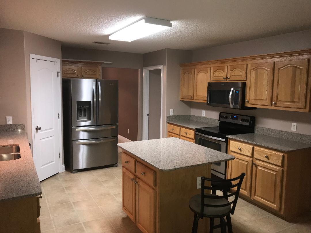306 Greyfox Circle Crestview, FL 32536 - Photo 4 of 23 a kitchen with stainless steel appliances granite countertop a refrigerator stove top oven and sink