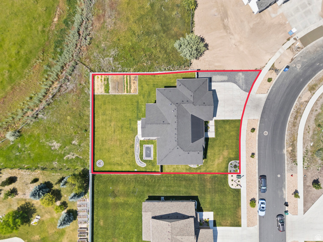 3111 South 1250 West Logan, UT 84321 - Photo 50 of 51 Aerial view showcasing a property with a distinct dark-tiled roof and solar panel installation