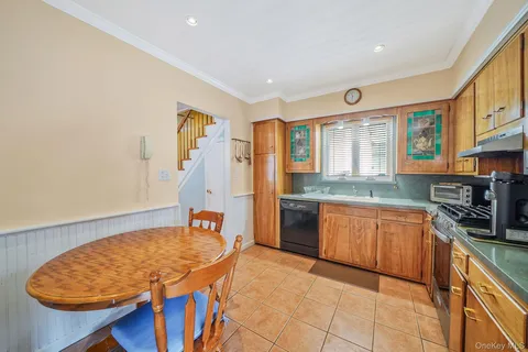 a kitchen with stainless steel appliances granite countertop a sink dishwasher stove and refrigerator with wooden floor