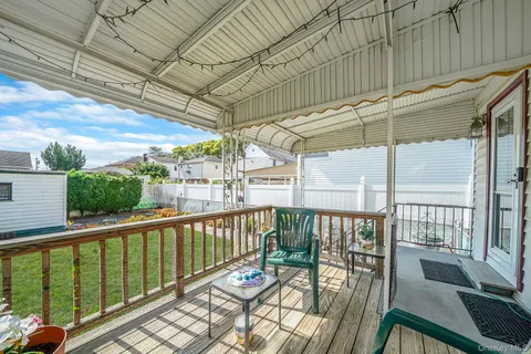 a view of a porch with wooden floor