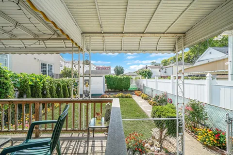 a view of a backyard with plants and a patio