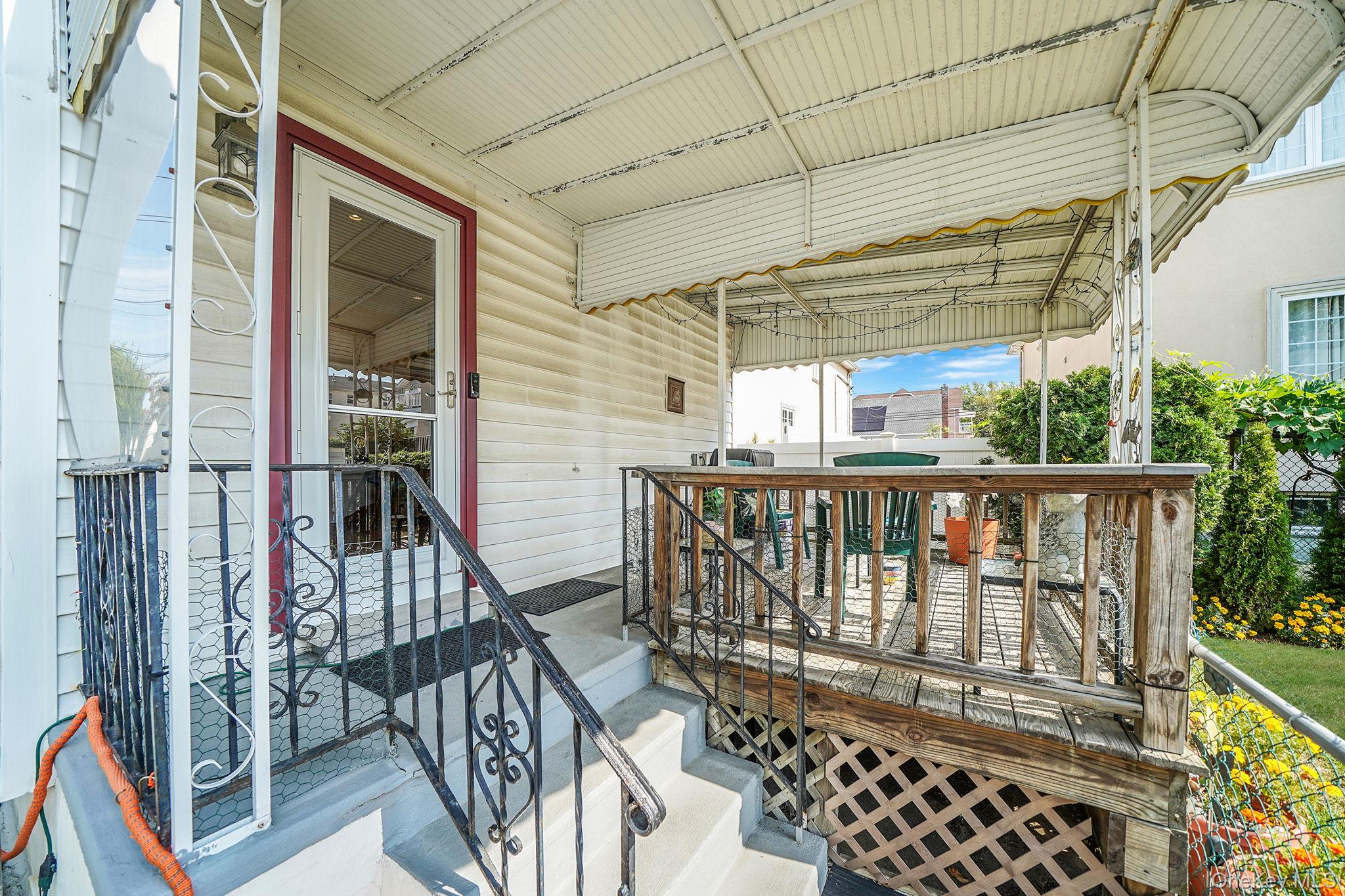 256-12 87th Road Floral Park, NY 11001 - Photo 29 of 33 a view of a porch with wooden floor