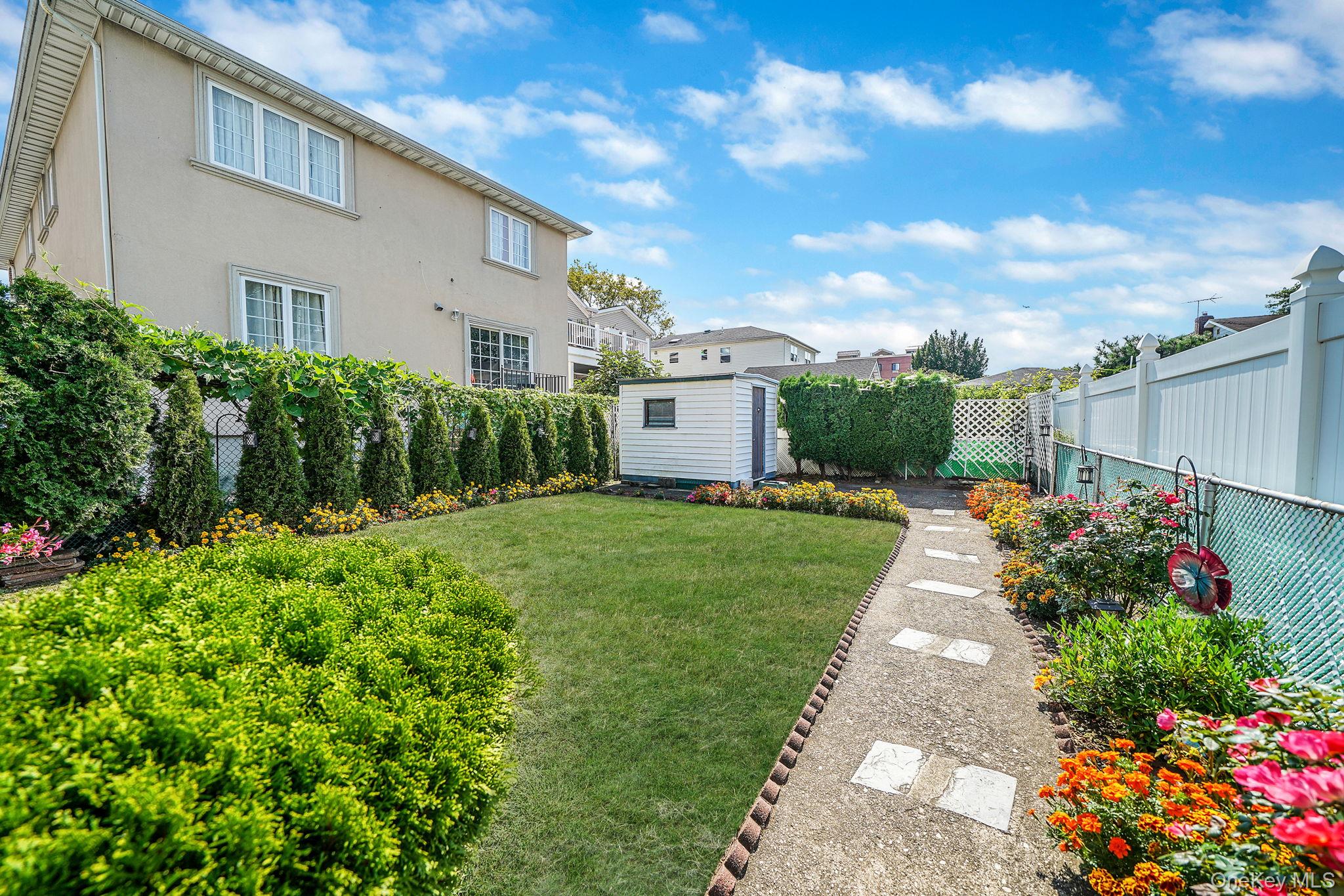 256-12 87th Road Floral Park, NY 11001 - Photo 31 of 33 a view of a house with a yard and garden
