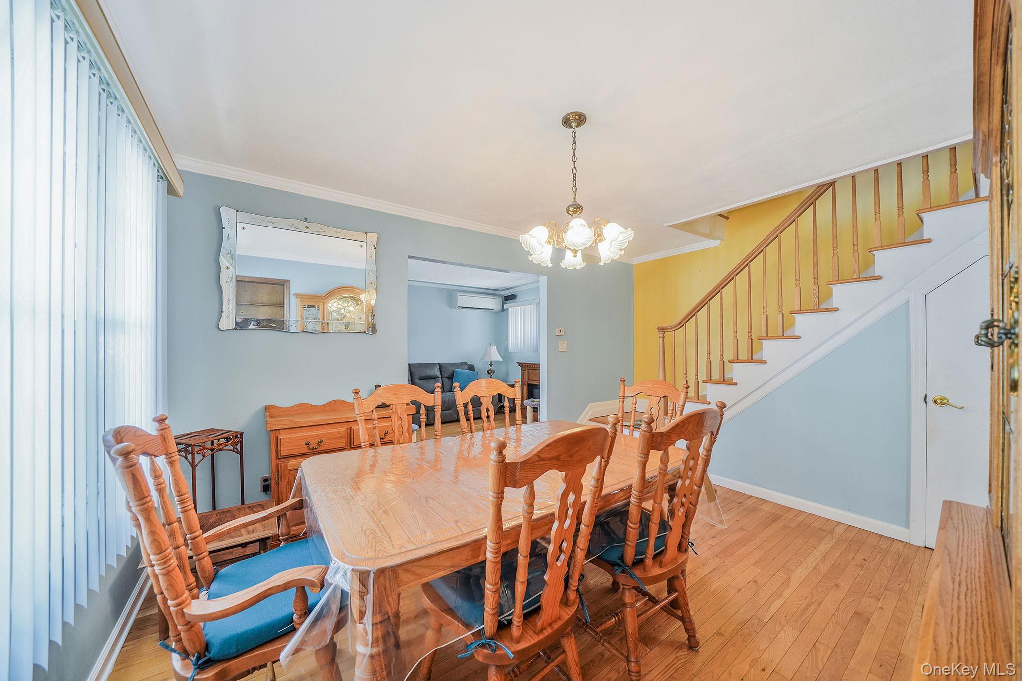256-12 87th Road Floral Park, NY 11001 - Photo 9 of 33 a view of a dining room with furniture and wooden floor