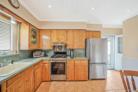 a kitchen with stainless steel appliances granite countertop a refrigerator stove microwave and sink