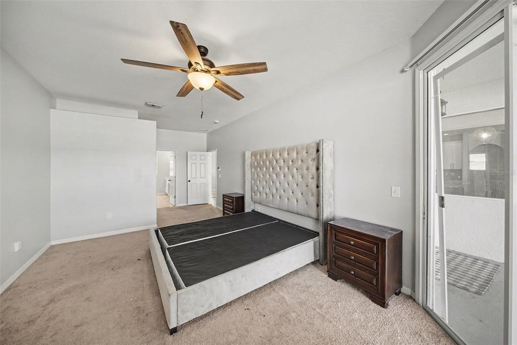 4809 Walnut Ridge Road Land O' Lakes, FL 34638 - Photo 12 of 34 a living room with a couch and a ceiling fan