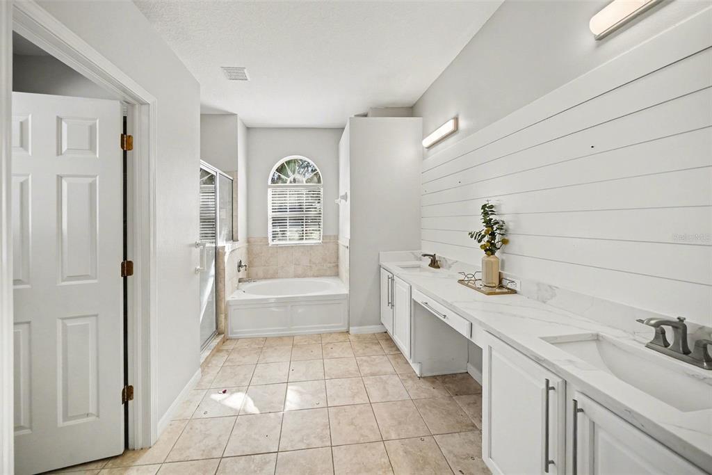 4809 Walnut Ridge Road Land O' Lakes, FL 34638 - Photo 14 of 34 a spacious bathroom with a granite countertop sink a toilet and bathtub